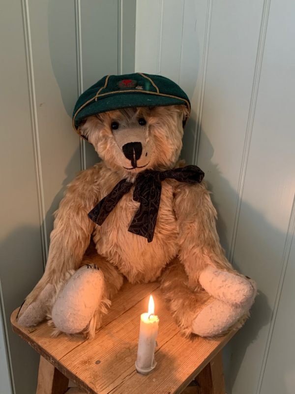 Bertie with Bobby's Wolf Cub cap sat behind a candle lit for Diddley..