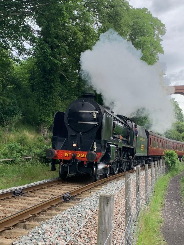 Schools Class "Repton" pulling a train under a viaduct on the North Yorkshire Moors Railway.