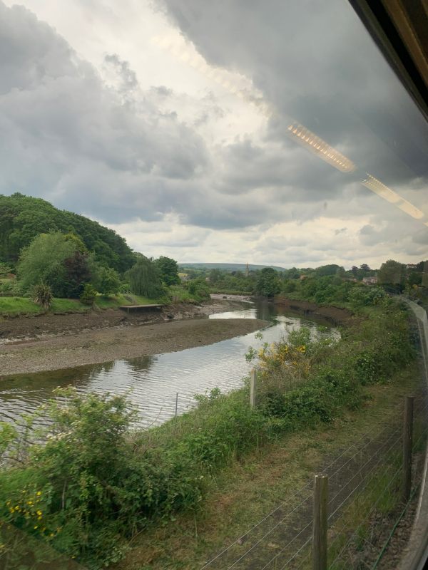 Looking out the train window at the dark threatening clouds over the River Esk.
