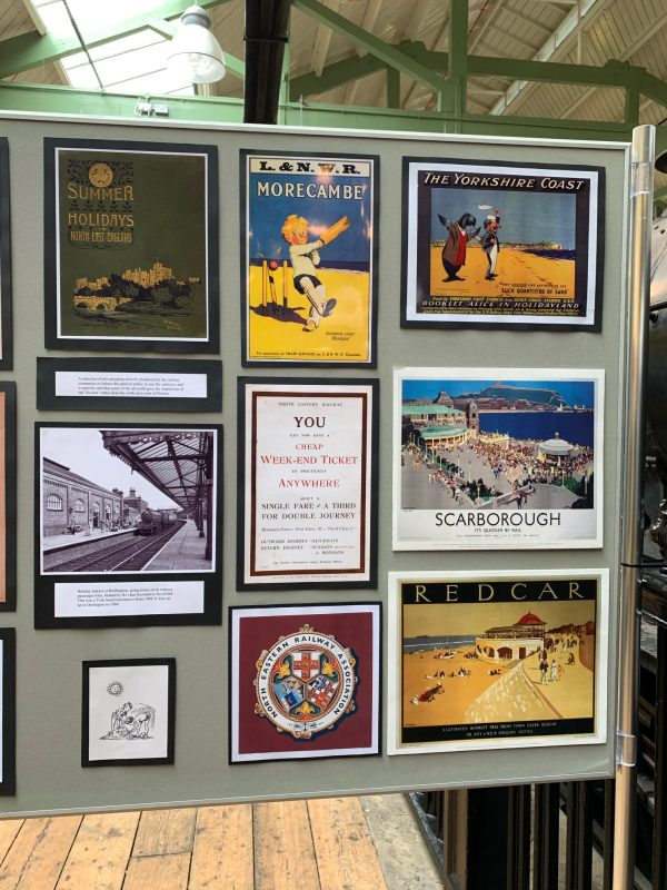 A display board of old railway posters.
