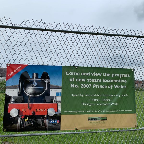 Banner on the fence outside Darlington Locomotive Works advertising another brand new steam engine under construction. 2007 Prince of Wales. P2 Class.
