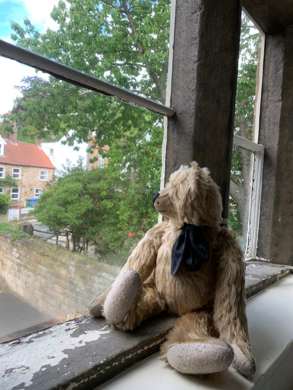 Bertie still in the window of the B&B looking out and ignoring Bobby.