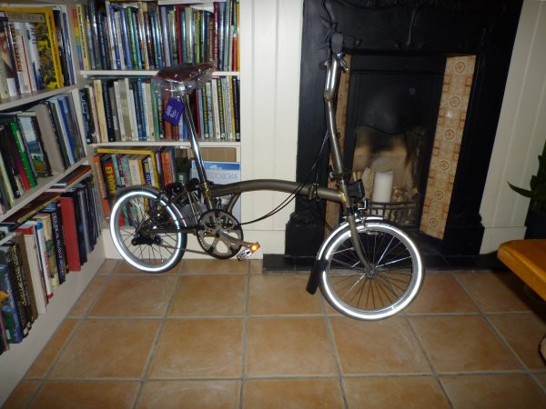 The Brand new Brompton bike in the lounge leant up against the bookcase alongside the fireplace.