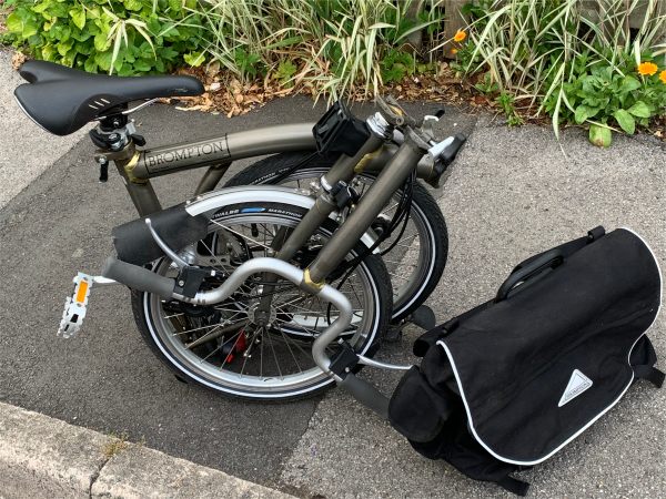 The Brompton folded up on the pavement.