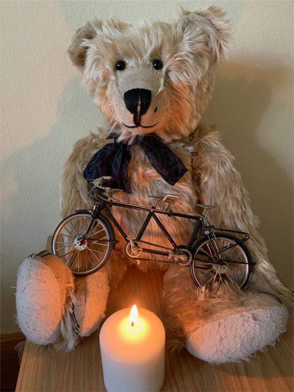 Bertie sat on a table with a model tandem on his lap and a candle lit for Diddley in front.