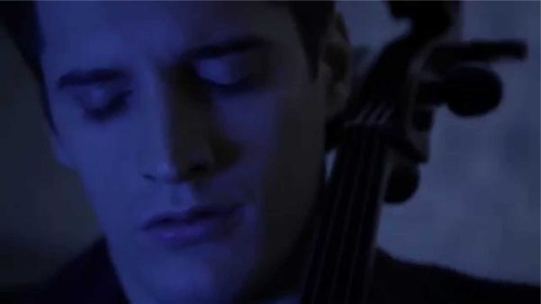 A blue, monochrome picture of a musician's head and the top of a 'cello.