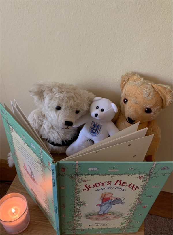 Trevor, Ellen and Eamonn gathered around Jody's Beans, with a candle lit for Diddley.