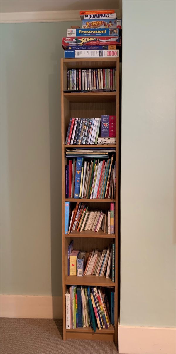 Layla's Library - A tall, narrow bookcase laden with books.