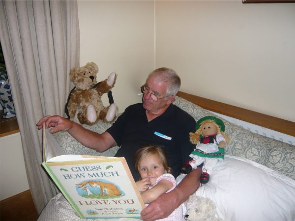 Bobby reading the book "Guess How Much I Love You" to Layla, with Bertie and Heidi - an Austrian doll.
