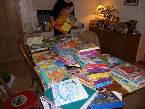 Diddley bringing the books in and covering a big table with them.