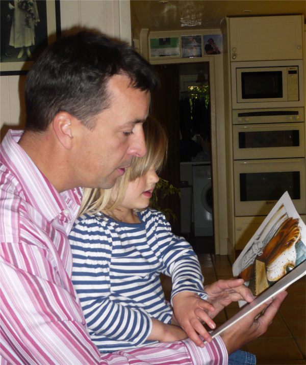 Uncle Andrew reading to Layla.