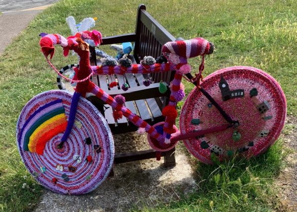 Yarnbomb Sisters - knitted bicycle complete with "NHS rainbow".