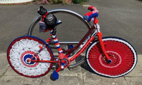 Yarnbomb Sisters - knitted bicycle in Red, White and Blue.