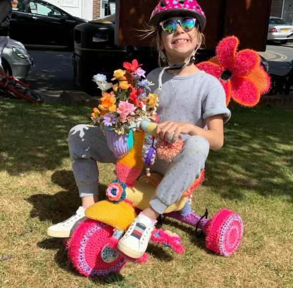 Yarnbomb Sisters - knitted child's tricycle (with child!)