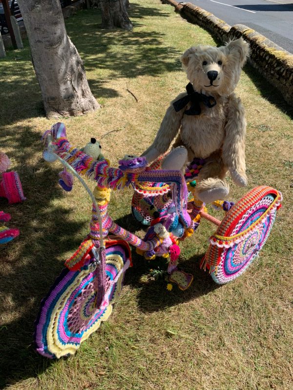 Yarnbomb Sisters - Bertie sat on a knitted tricycle