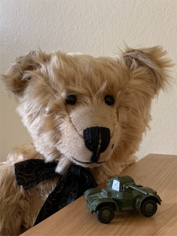 Bertie looking at a Dinky Toy model of an armoured car.
