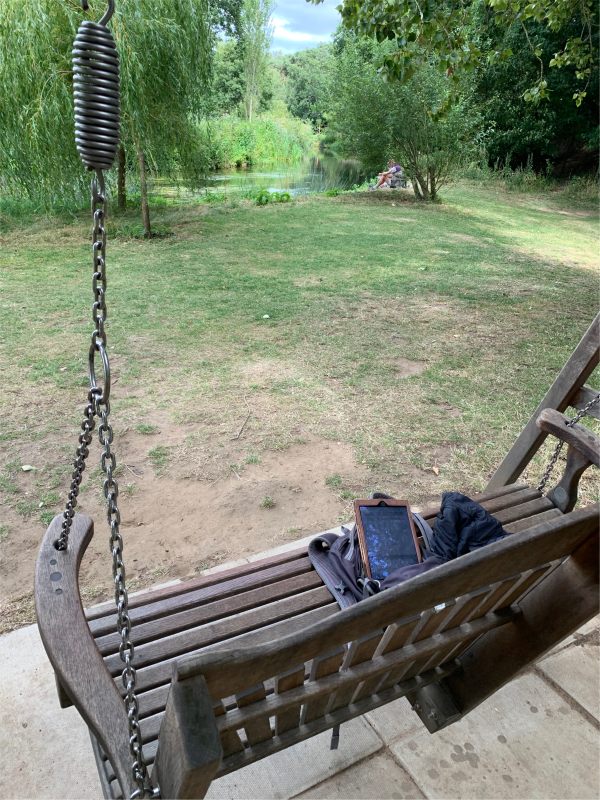 Swing seat by the river at Wisley Gardens.