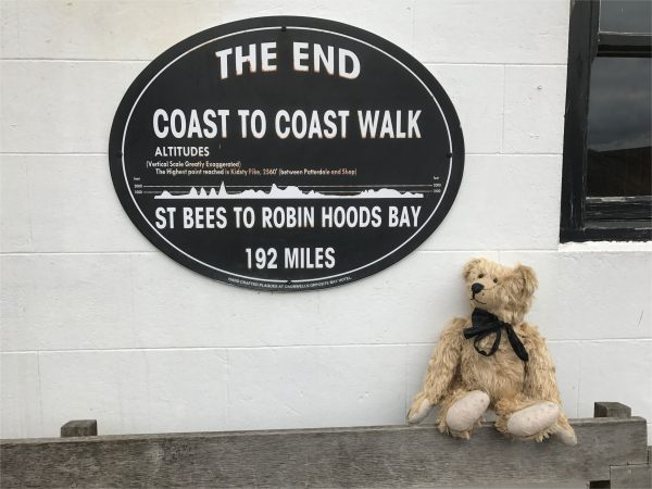 Bertie sat on a bench on front of a plaque marking the end of the Coast to Coast Walk - all 192 miles of it!