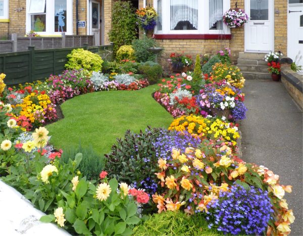 Beautifully manicured lawn and immaculate, brightly coloured flower beds.