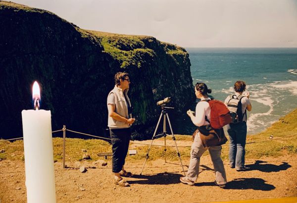 Diddley on duty on Skomer. A candle lit for Diddley is in the foreground.