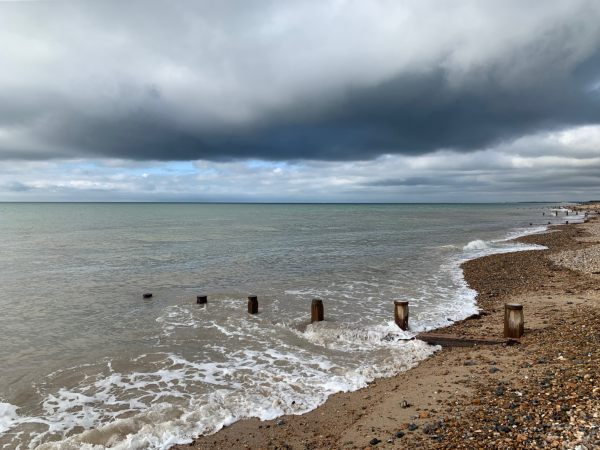 Looking west. Impressive clouds threatening rain, but letting sunshine through here and there. Ventnor, on the Isle of Wight, just visible to the naked eye.