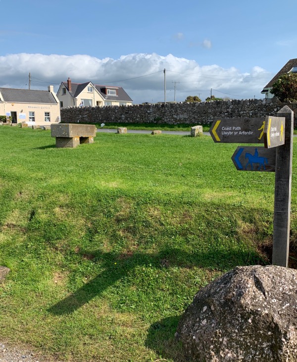 Follow the coast path sign.