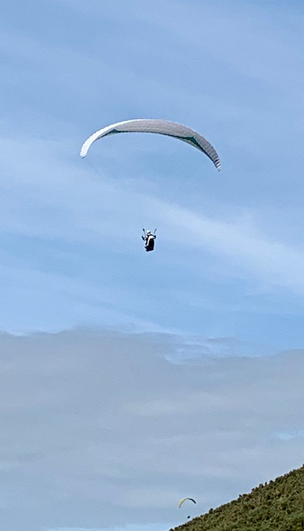 Hang gliders over Rhossili Downs.