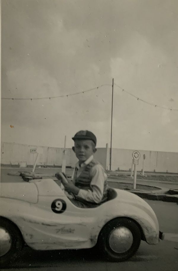 Bobby in a model car on a track.