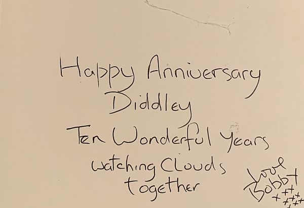 The handwritten inside of the "Cloud Watching" card: Happy Anniversary, Diddley. Ten wonderful Years watching clouds together. Love Bobby" with 9 "x's" in three rows of three underneath.