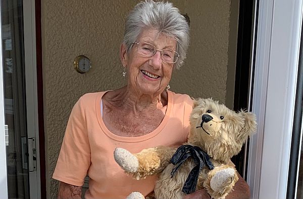 Rosemary, outside her front door, holding Bertie.