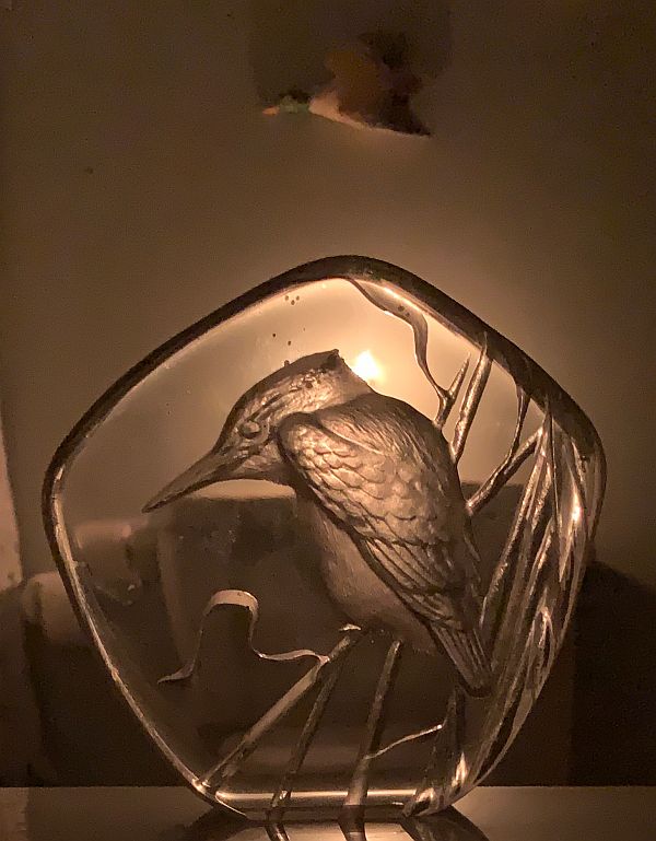 Glass paperweight with an image of a Kingfisher in it, silhouetted against a candle lit for Diddley.