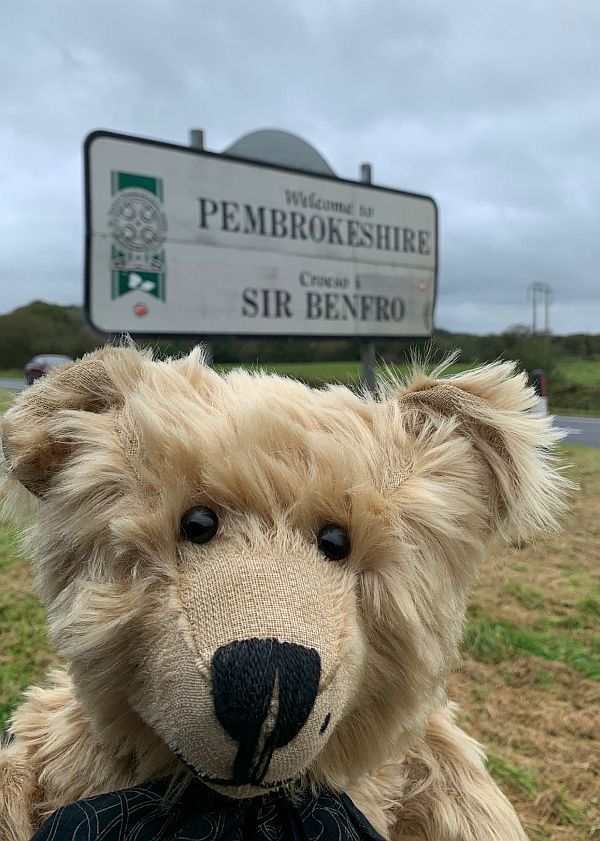 Bertie by the street sign for Pembrokeshire (Sir Benfro).