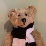 Bertie wearing his black and white Fulham scarf.