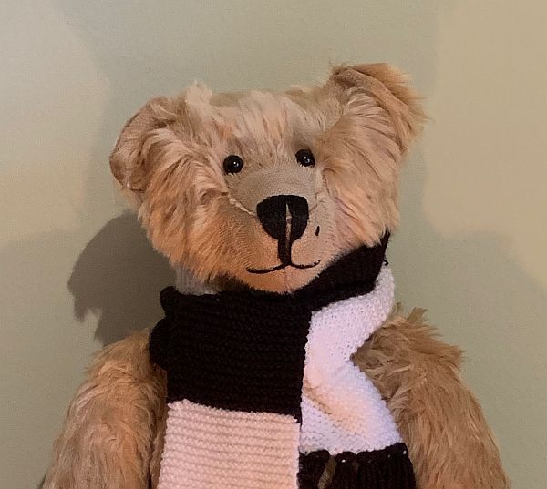 Bertie wearing his black and white Fulham scarf.
