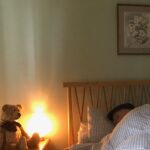 Bertie looking at Bobby asleep in bed.
