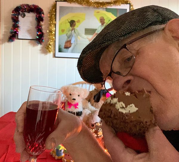 Bobby stuffing his face with cake, glass of wine in hand!