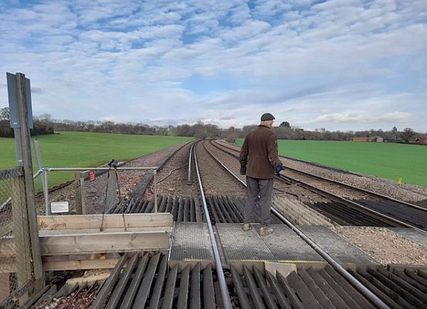 Bobby standing in the middle of the Railway Crossing looking north, towards Holmwood.