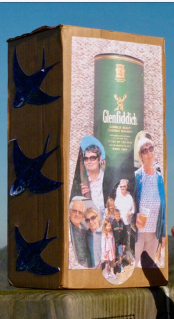 The ashes in a box with pictures of a Glenfiddich box plus photos of Diddley & Bobby.