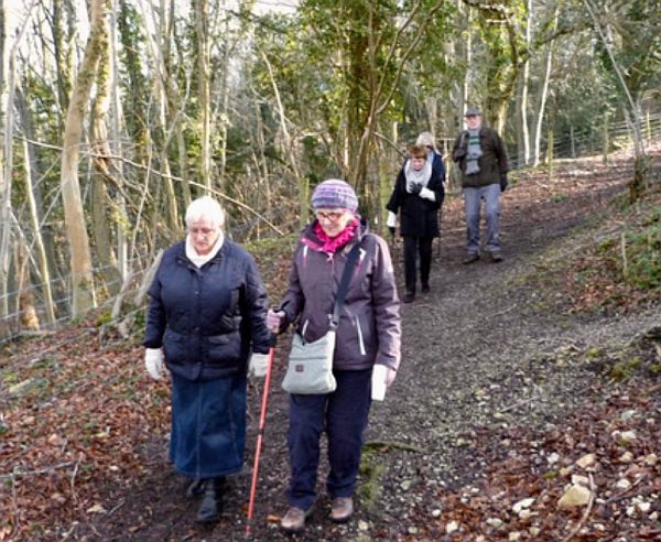 Bobby and the four ladies walking back through the woods.