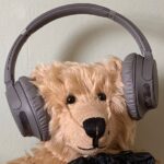 Can you hear me now? Bertie waving headphones.