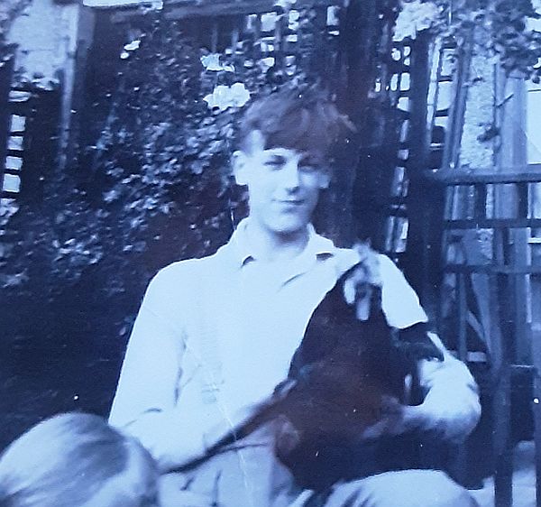 Bobby's brother, Tony, with a chicken in the garden.