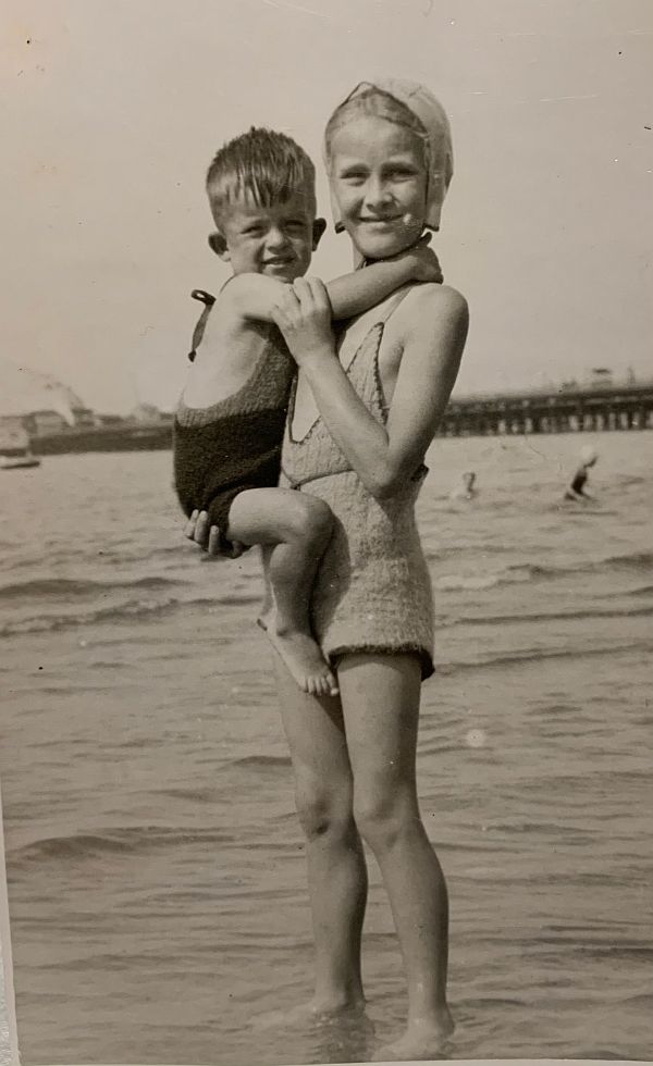 Bobby & Wendy paddling at the beach wearing knitted swimming costumes.