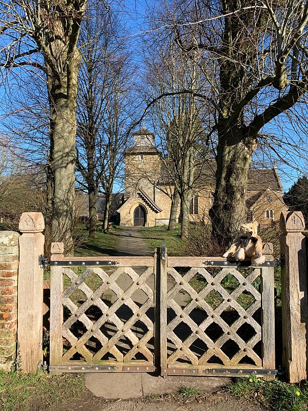 Wotton Church as seen through the ornate entrance gate.