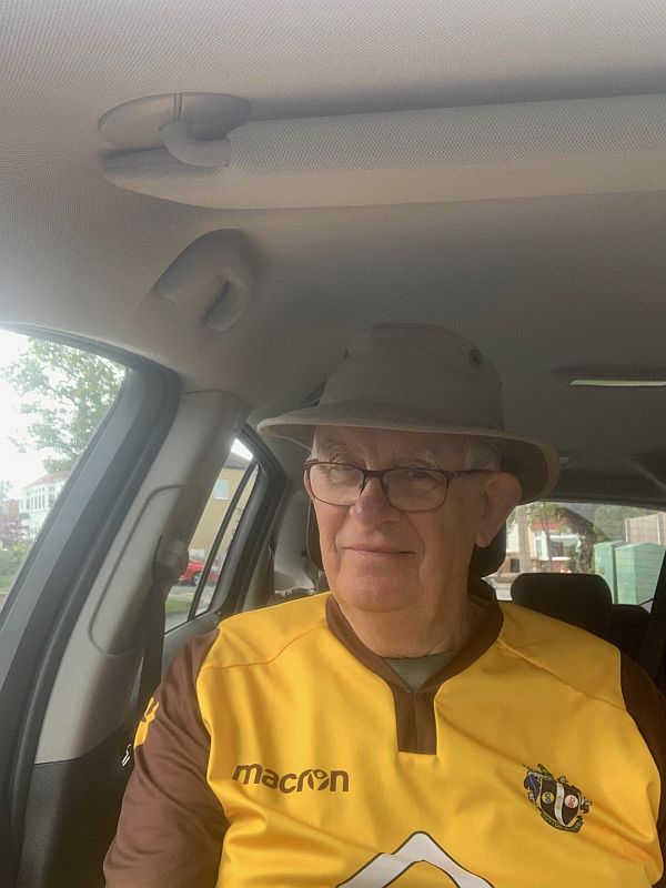 Bob in his Sutton United shirt in his car.
