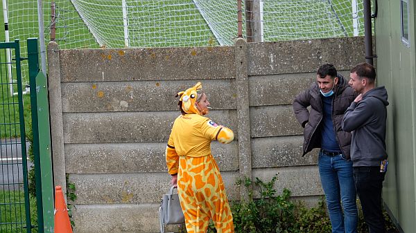 Club mascot having a fag.