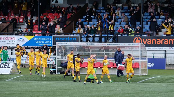 Sutton United team coming onto the ground.