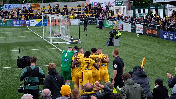 Team celebrating their third goal.