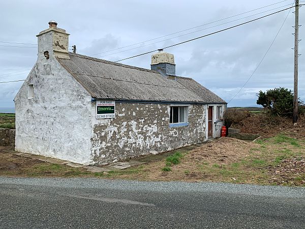 Slightly run-down cottage for sale.
