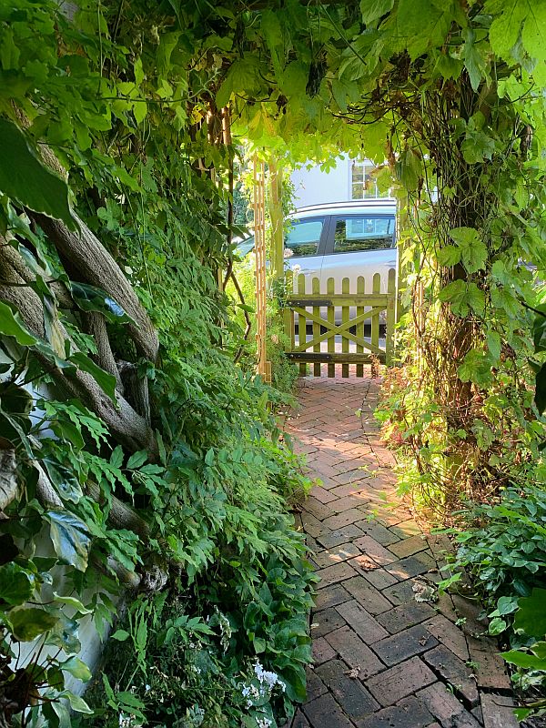 Down the curved herringbone front path.