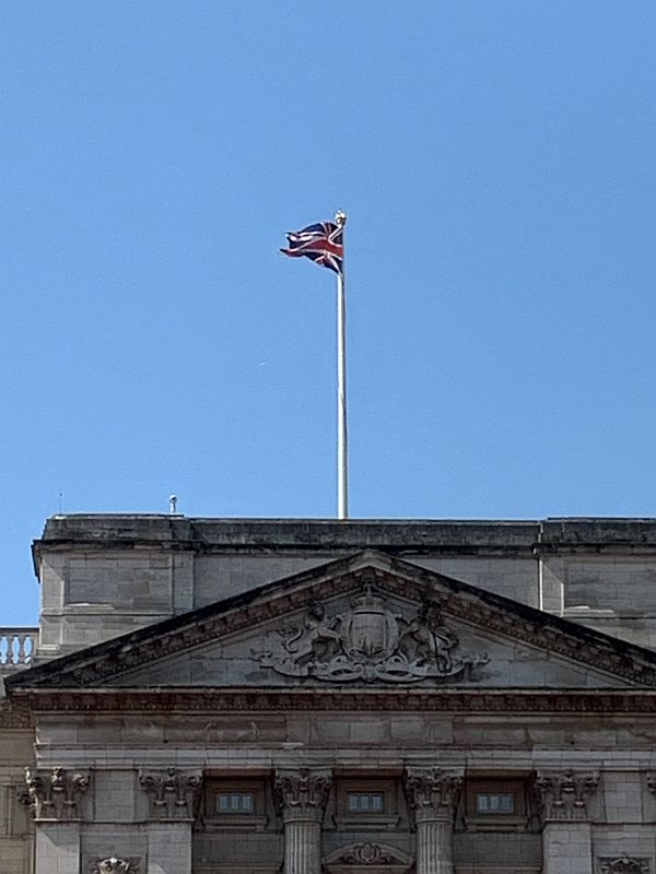 Union Jack flying high on Buckingham Palace.